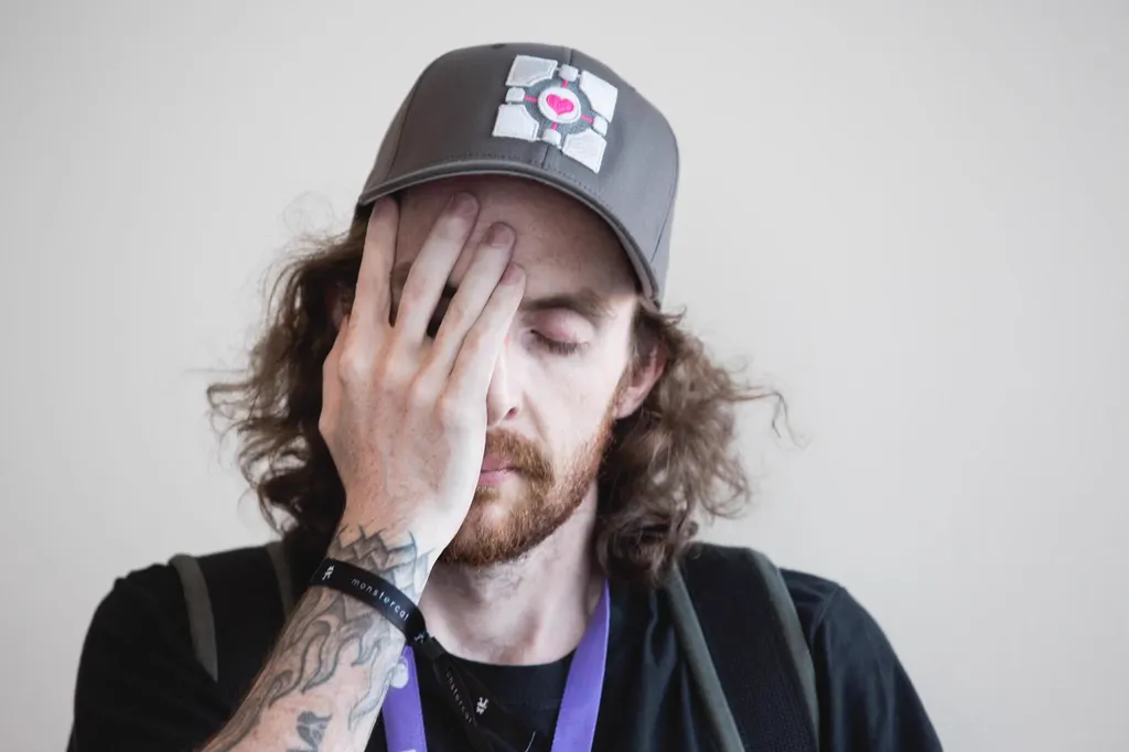 Spamfish facepalming in a Portal Companion Cube cap